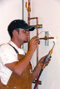 a Watauga Plumber solders a new line